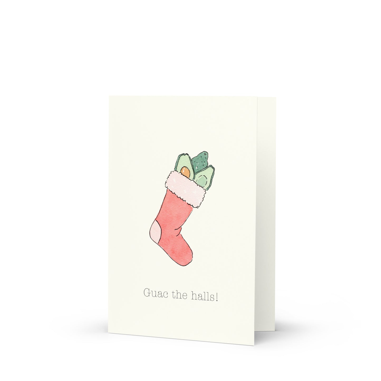 Greeting card with a Christmas stocking filled with avocados illustration and text that reads: "Guac the halls" on a white background