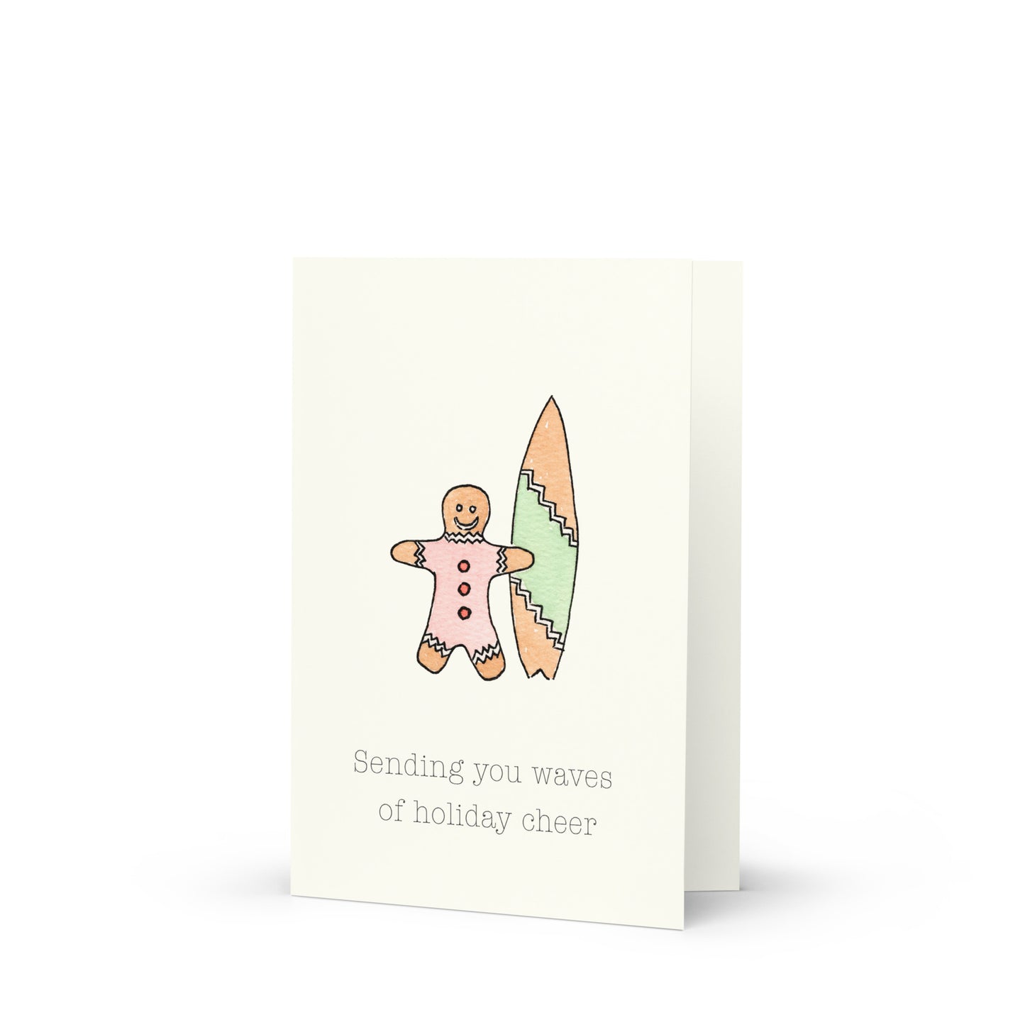 Greeting card with a gingerbread man and surfboard illustration and text 'Sending you waves of holiday cheer'.