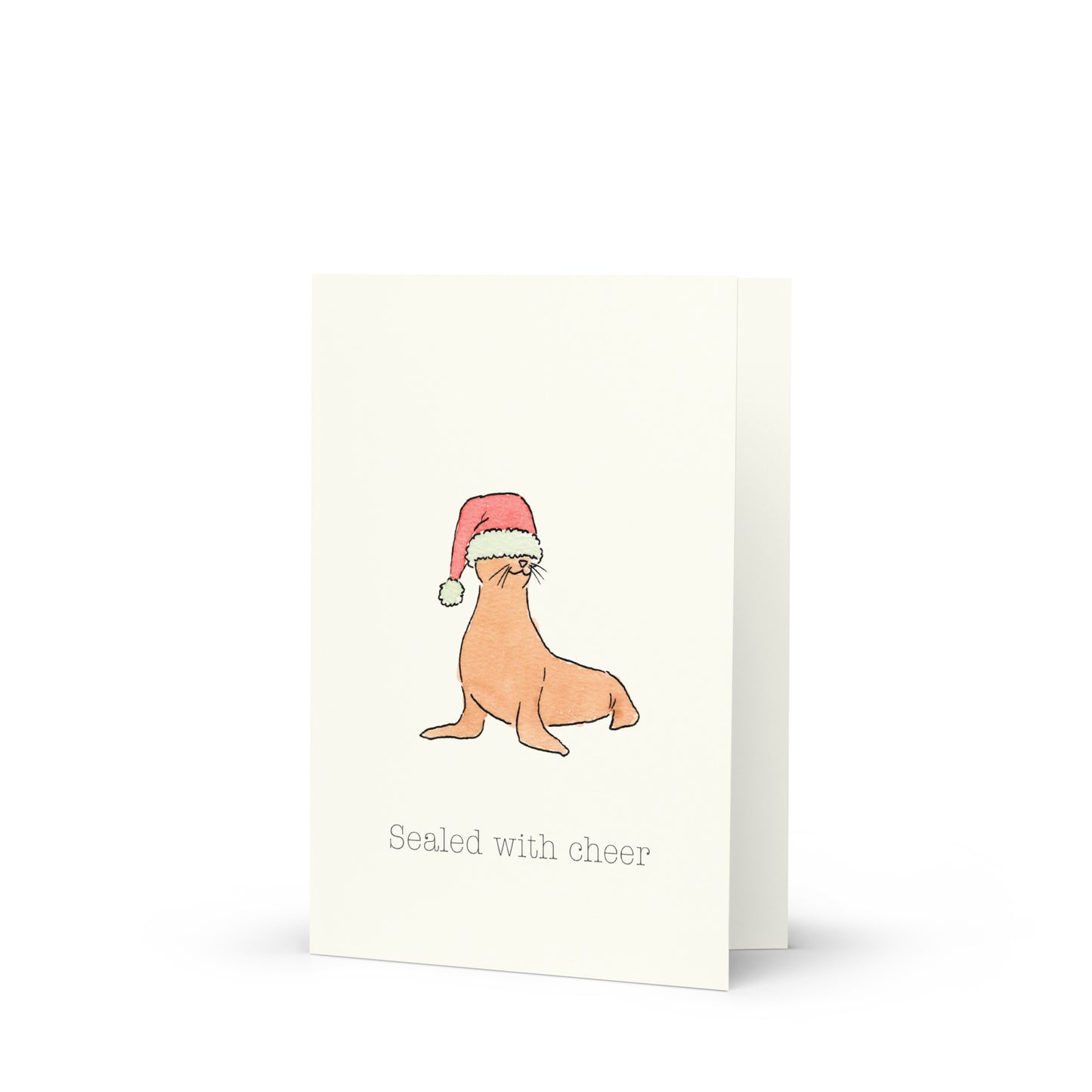 Greeting card with a seal wearing a Santa hat and text 'Sealed with cheer' on a white background