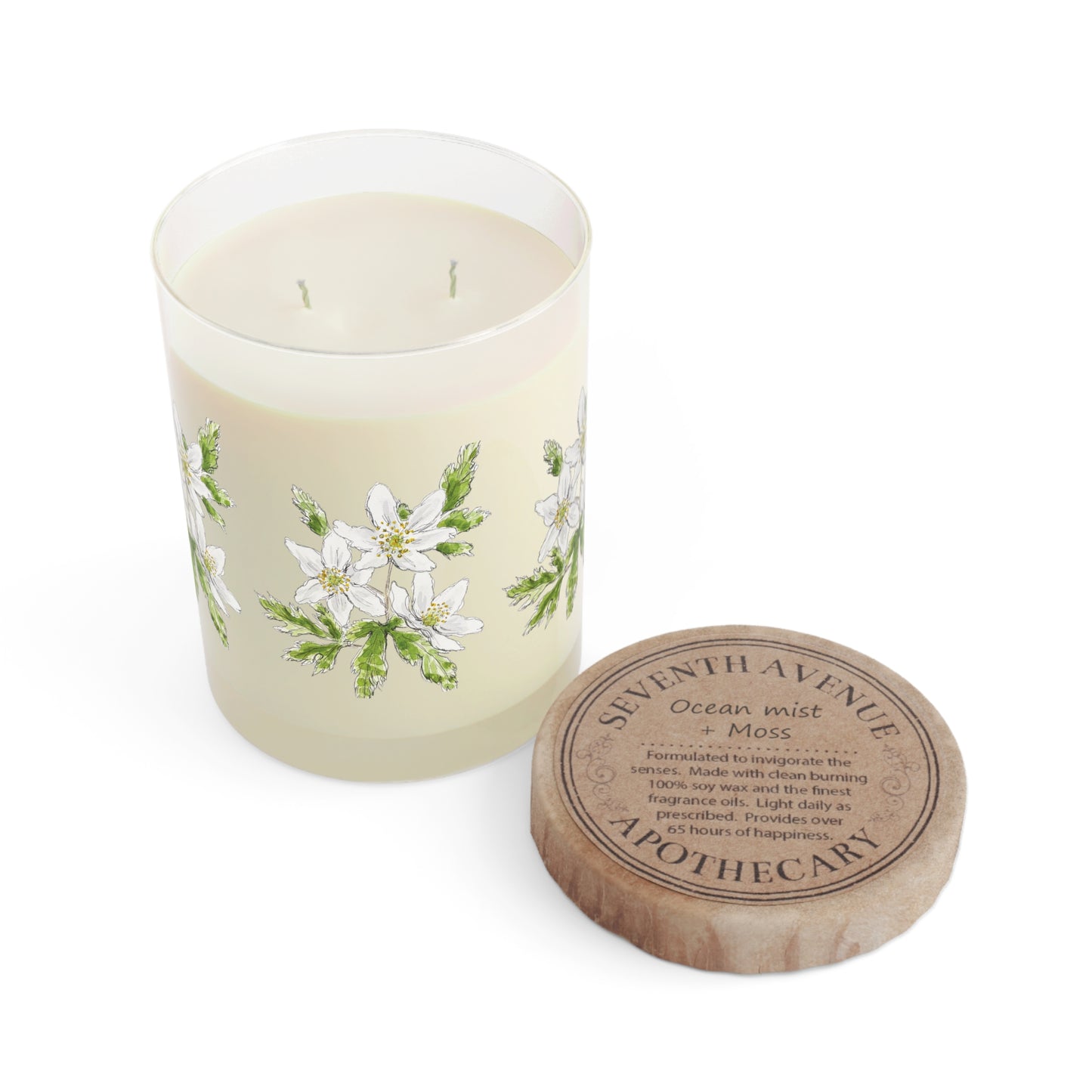 Luxury soy candle in a glass jar featuring a wood anemone flower watercolor design, paired with a rustic wooden lid engraved with 'Seventh Avenue Apothecary' with Ocean mist & moss scent