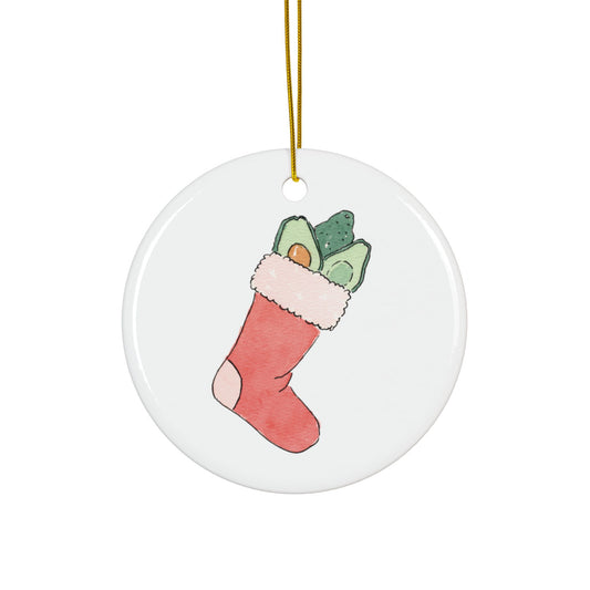 Round ceramic ornament with a Christmas stocking filled with avocados design on a white background