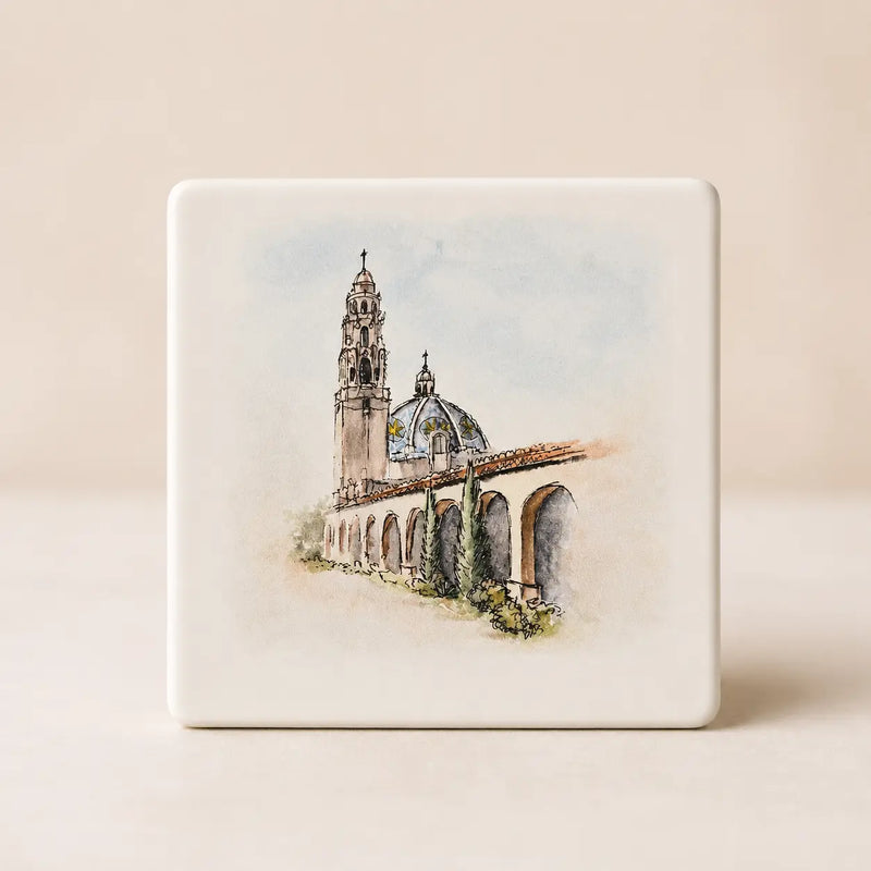 Square ceramic coaster with a watercolor depiction by Swil Arts, of the California Tower in Balboa Park, San Diego, on a beige background