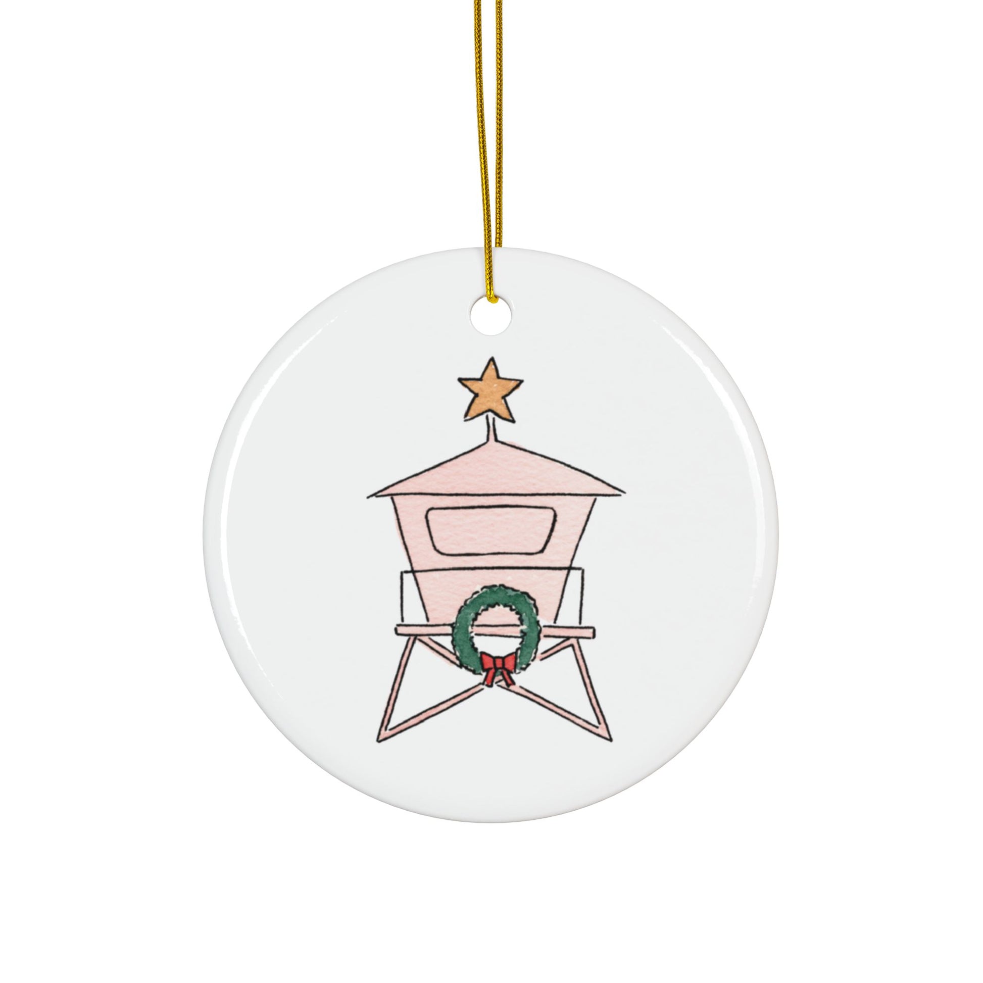 Round ceramic ornament with a lifeguard tower design, featuring a wreath and star on a white background.