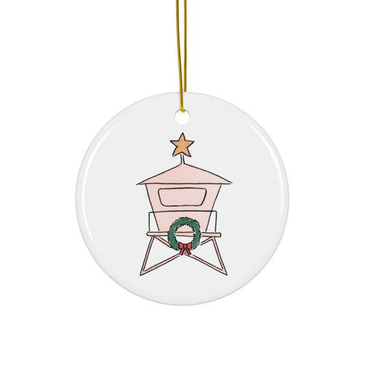 Round ceramic ornament with a lifeguard tower design, featuring a wreath and star on a white background.