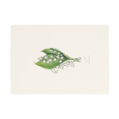 Botanical watercolor tea towel featuring a lily of the valley flower illustration by Swil Arts. This elegant, eco-friendly kitchen towel showcases a delicate ink and watercolor rendering of white lily of the valley with green leaves on a soft, neutral fabric. A perfect blend of art and functionality, this nature-inspired tea towel adds a touch of botanical beauty to any kitchen or dining space. Ideal for floral enthusiasts.