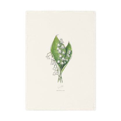 Botanical watercolor tea towel featuring a lily of the valley flower illustration by Swil Arts. This elegant, eco-friendly kitchen towel showcases a delicate ink and watercolor rendering of white lily of the valley with green leaves on a soft, neutral fabric. A perfect blend of art and functionality, this nature-inspired tea towel adds a touch of botanical beauty to any kitchen or dining space. Ideal for floral enthusiasts.