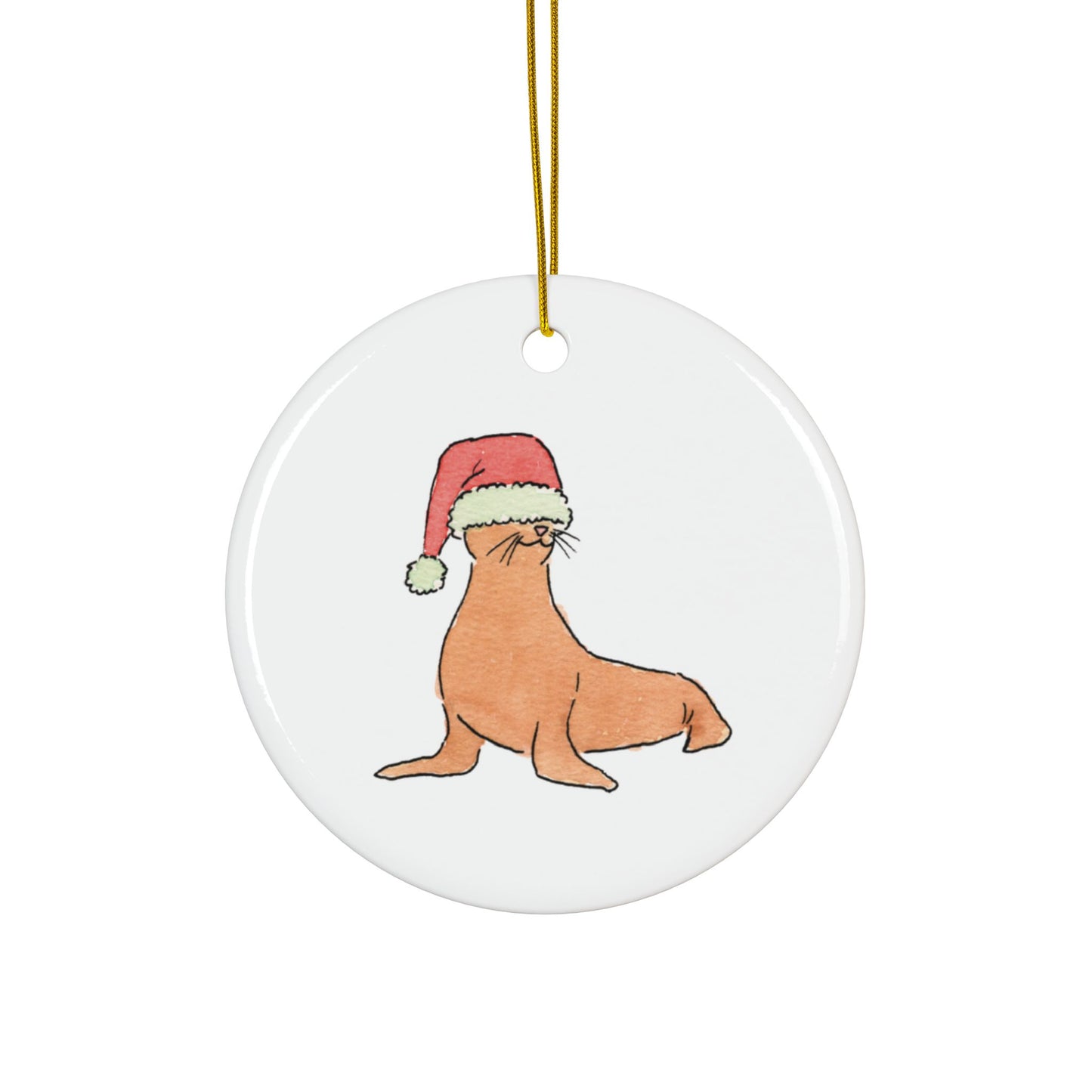 Round ceramic ornament with a seal wearing a Santa hat on a white background