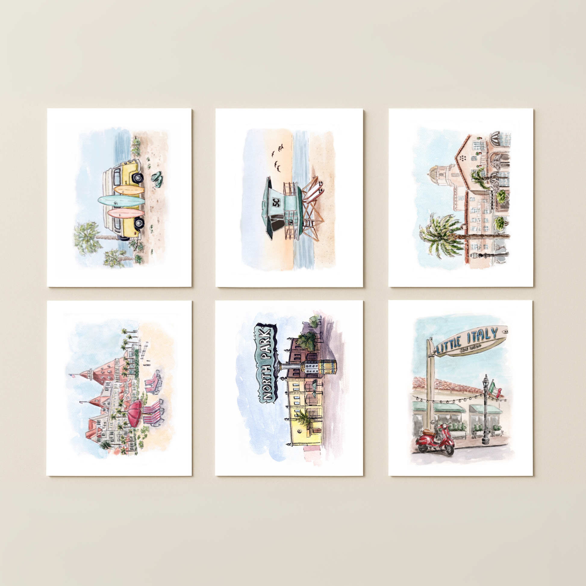 The Southern California Greeting Card Box Set - Watercolor Art features six cards with beach and city scenes, including buildings, a pier, a lifeguard tower, and a vintage camper van—perfect for fans of SoCal-inspired artwork.