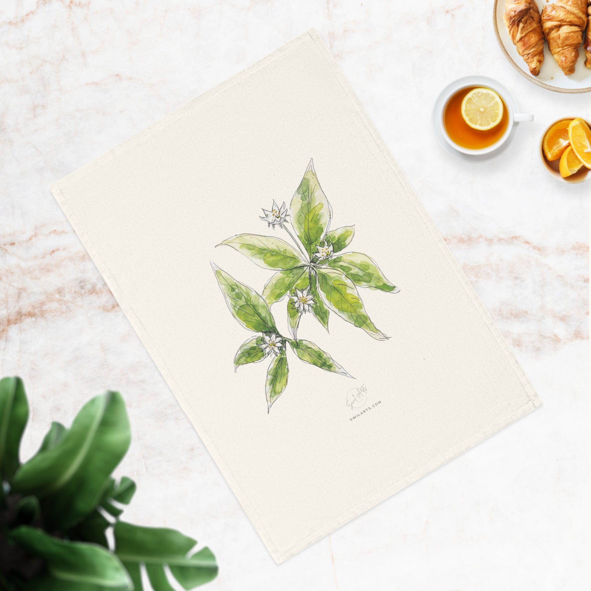 Botanical watercolor tea towel featuring a starflower illustration by Swil Arts. This elegant, eco-friendly kitchen towel showcases a delicate ink and watercolor rendering of white starflower with green leaves on a soft, neutral fabric. A perfect blend of art and functionality, this nature-inspired tea towel adds a touch of botanical beauty to any kitchen or dining space. Ideal for floral enthusiasts,