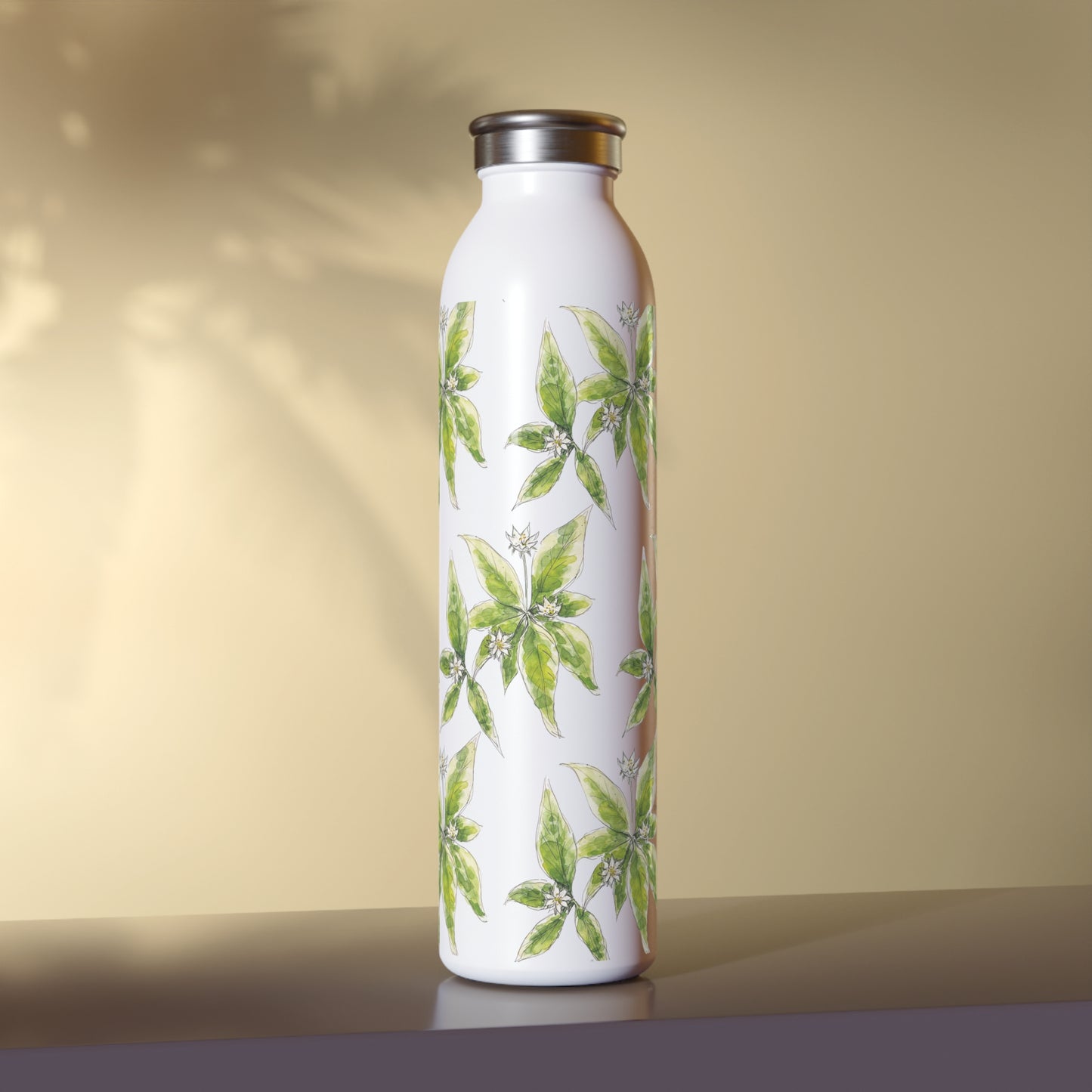 White stainless steel water bottle featuring a starflower watercolor pattern, set against a warm beige background with soft leaf shadows.