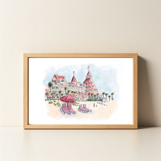 Framed watercolor painting of a beachfront hotel with beach chairs.