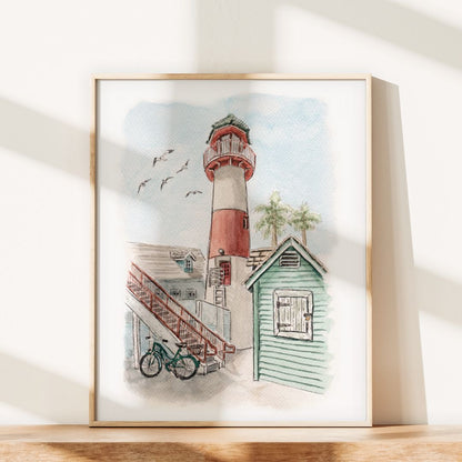 The Lighthouse Tale by Swil Arts is a framed coastal watercolor featuring a red and white lighthouse, green beach hut, bicycle, and seagulls—a charming choice for beach cottage decor.