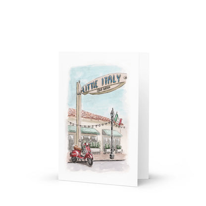 The Southern California Greeting Card Box Set features watercolor art with a Little Italy San Diego street sign, red scooter, Italian flag, and café—ideal for anyone who loves coastal charm and vibrant holiday cards.