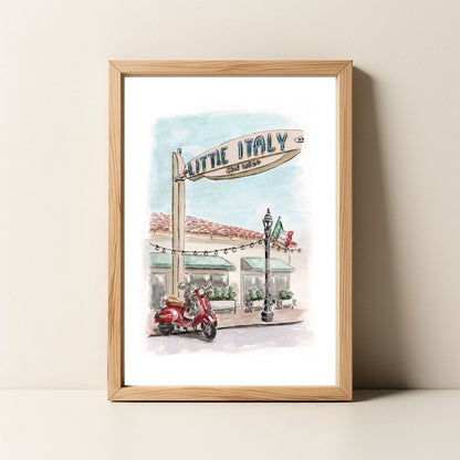 Framed watercolor painting of a Little Italy, San Diego street scene with a scooter, sign, and Italian flag.
