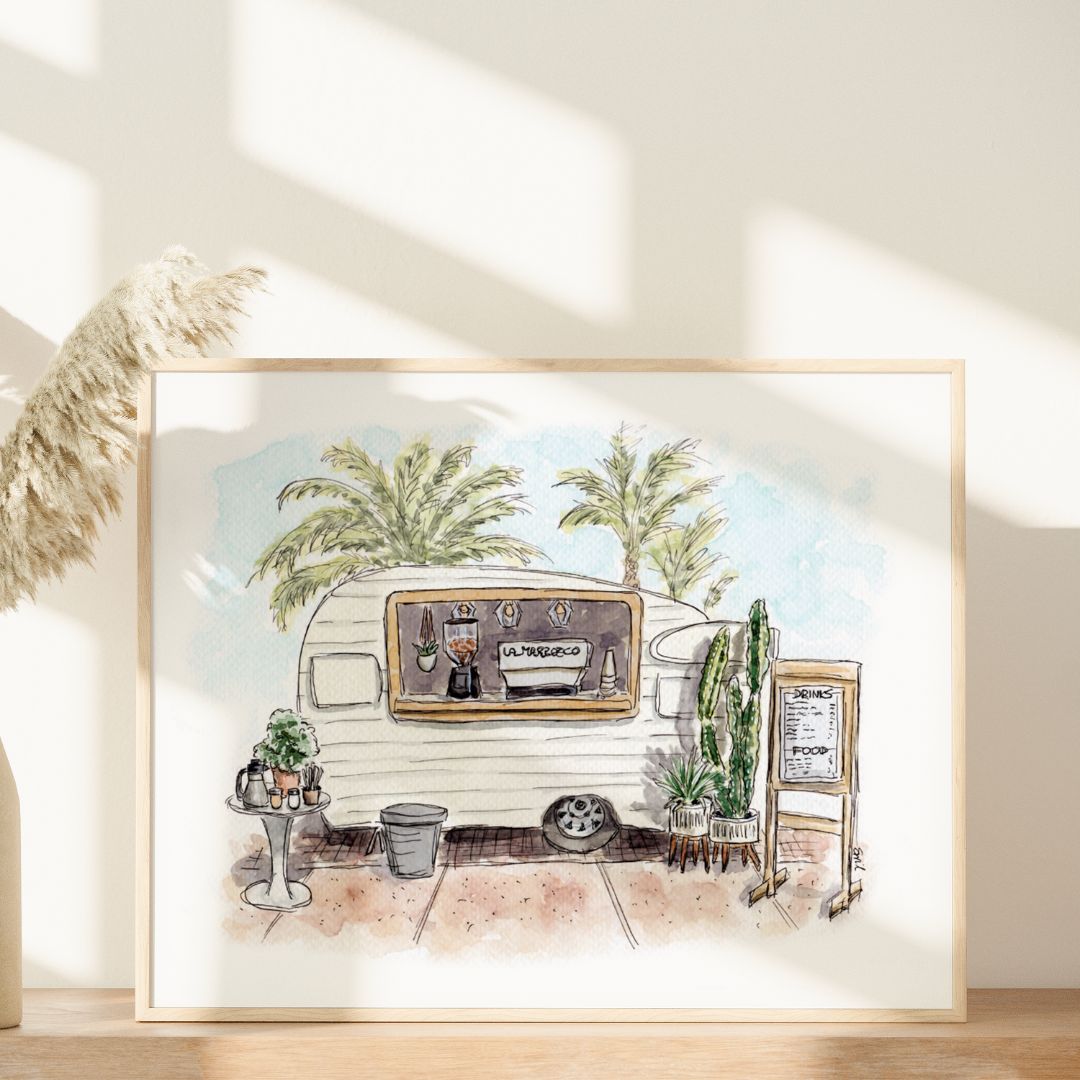 Vintage Vibes and Coffee Tides by Swil Arts is a framed coastal watercolor featuring a vintage coffee truck with menu sign, potted plants, and palm trees, displayed on a light wooden surface with pampas grass nearby.