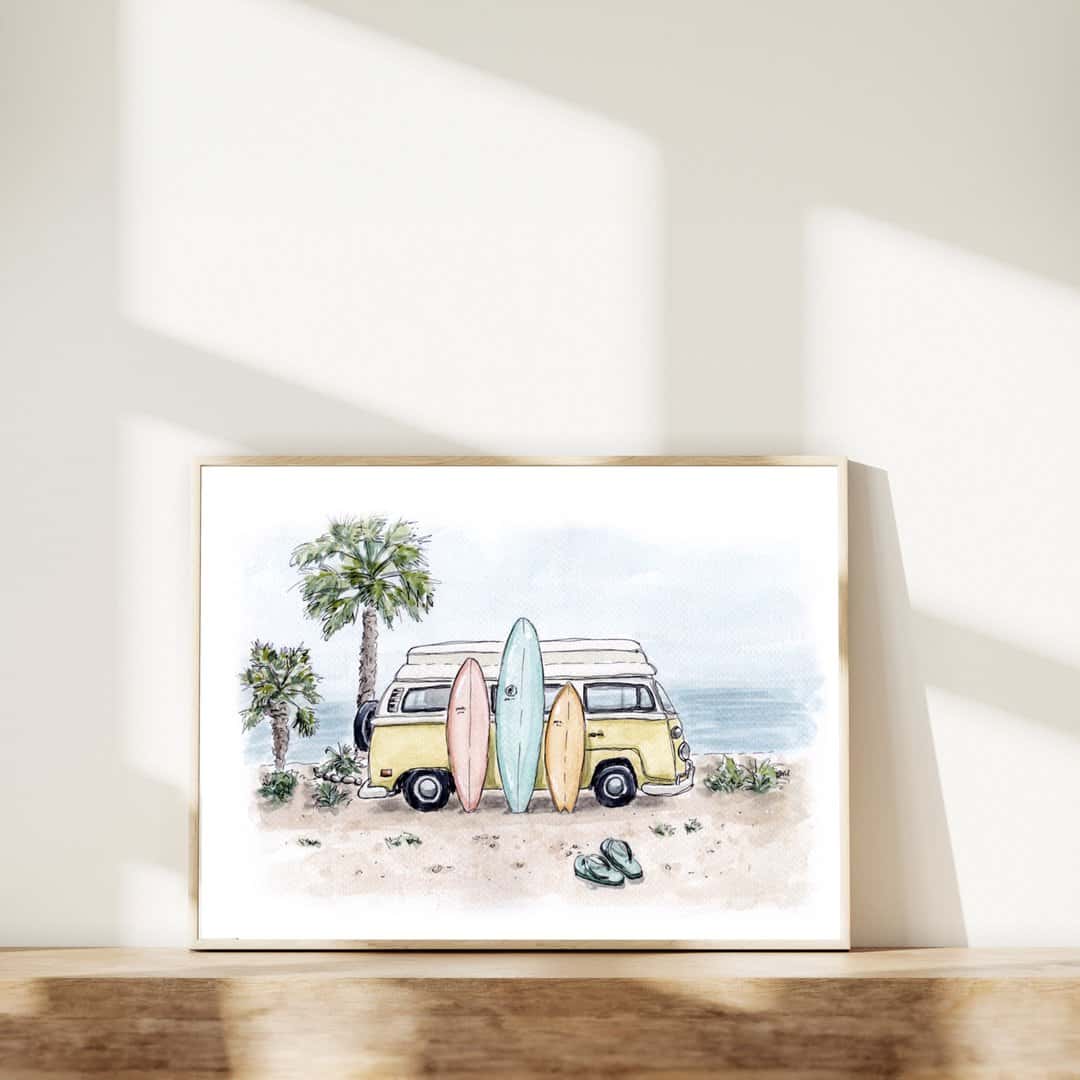 Watercolor art print of a yellow vintage surf van with surfboards on a beach, displayed in a wooden frame. Palm trees and ocean backdrop make this perfect beach decor. Surf and adventure-themed wall art for home or office
