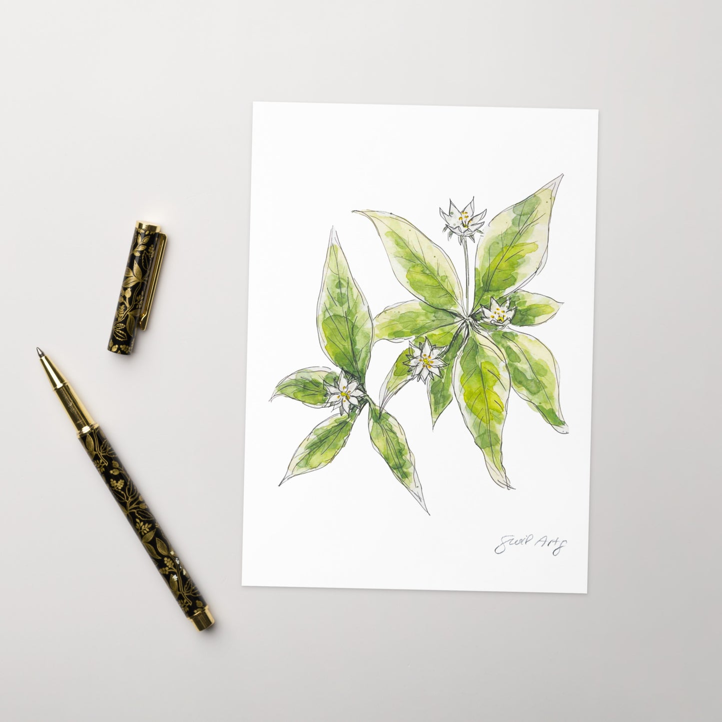 Starflower greeting card with a delicate watercolor and ink illustration. Botanical note card featuring a woodland-inspired floral design, perfect for nature lovers. The greeting card is nicely set with an elegant gold en next to it, ready to journal.