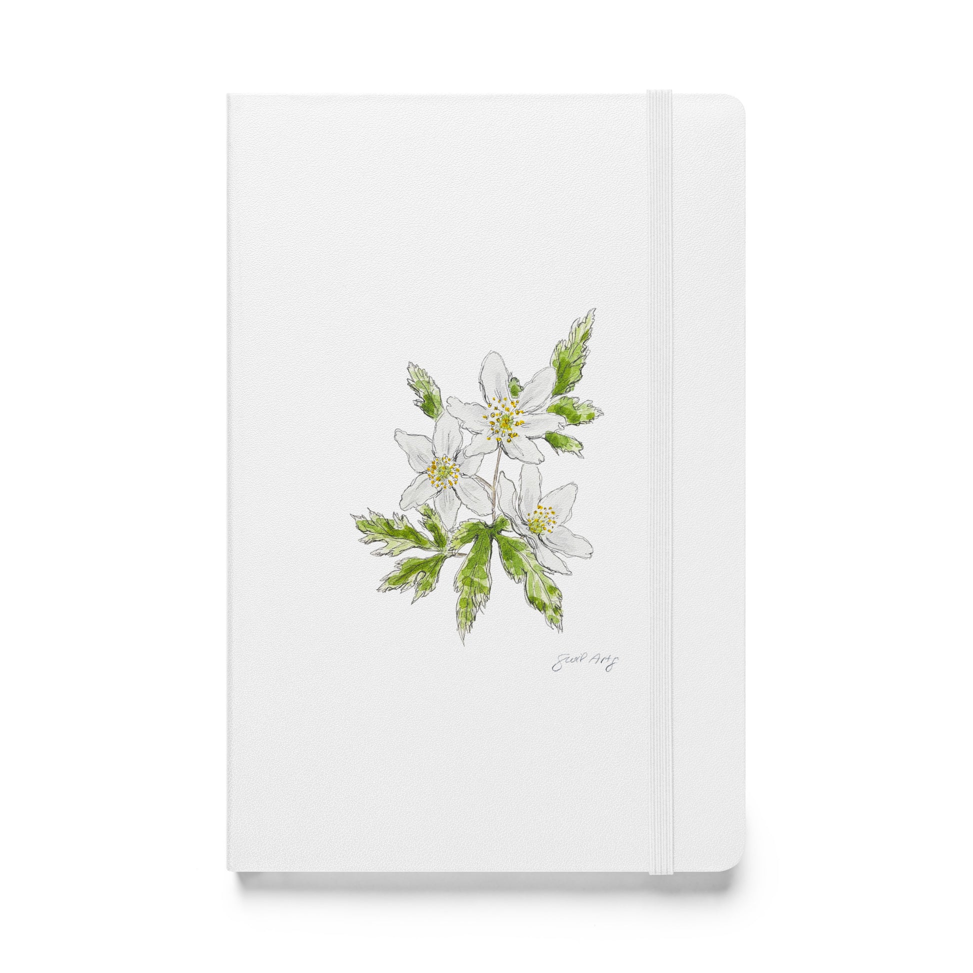 White hardcover notebook featuring a delicate wood anemone flower illustration by Swil Arts. This botanical watercolor and ink design showcases the beauty of nature, making it perfect for journaling, sketching, or note-taking. The notebook includes an elastic closure for convenience, ideal for artists, writers, and nature lovers seeking elegant stationery with a floral touch