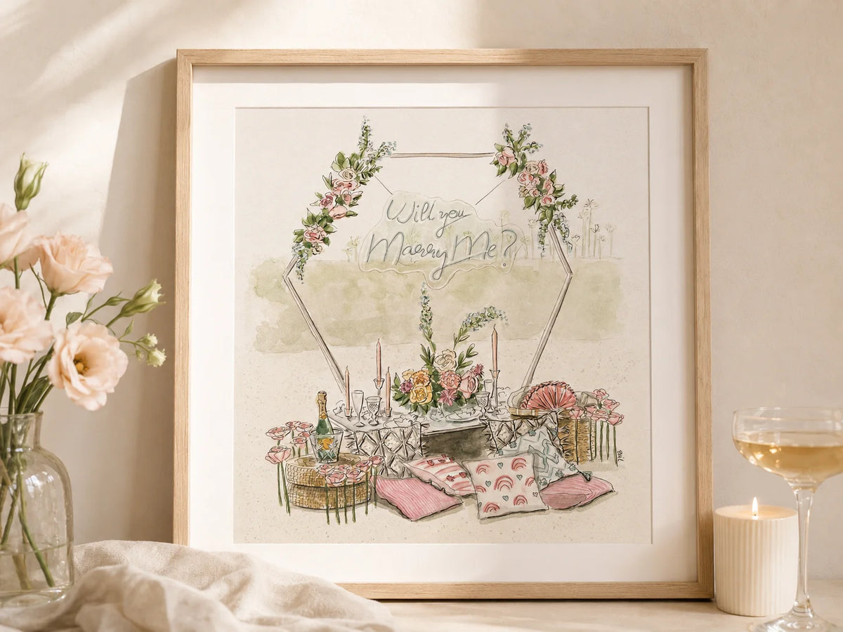 Framed watercolor artwork with a romantic scene of a dinner table and flowers, on a light background. And a caption that says: "Will you marry me?"
Artwork by Swil Arts