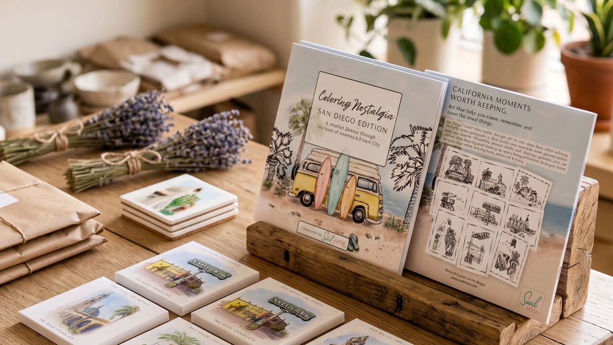 A styled tabletop display showing printed coasters and a small booklet or book in a wooden stand, with dried lavender and wrapped paper goods in the background. The main sellable item appears to be the printed coaster/book set, photographed in a warm indoor setting.