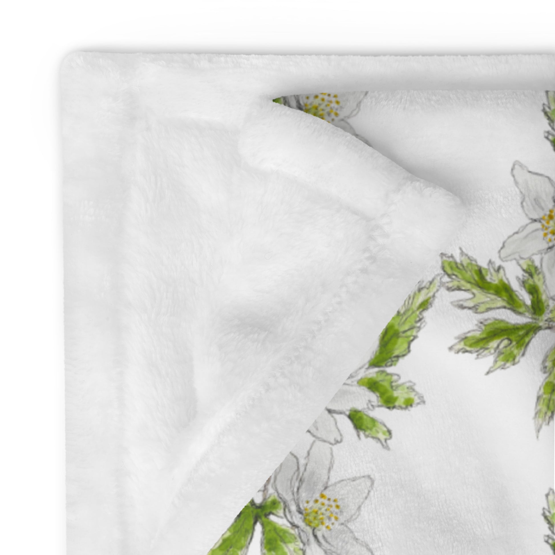 Plush fleece throw blanket with a white wood anemone flower watercolor pattern and soft sherpa lining. Cozy botanical home décor with a nature-inspired floral design.