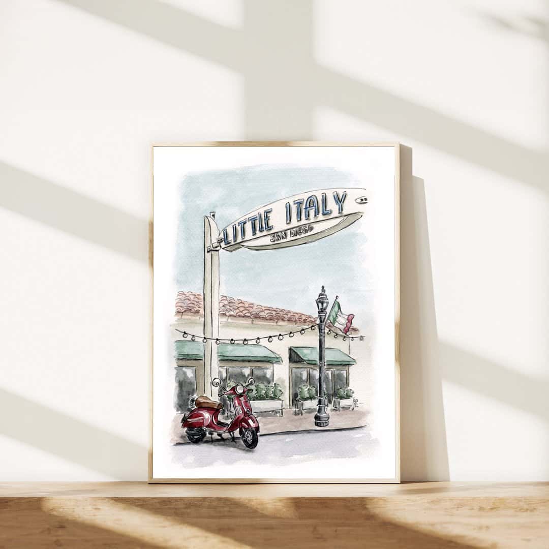 Framed watercolor print of Little Italy San Diego sign with a red Vespa scooter. Hand-painted Italian-inspired street scene art, perfect for stylish wall décor or travel-themed home accents